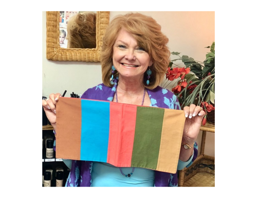 Photograph of woman holding up color drapes