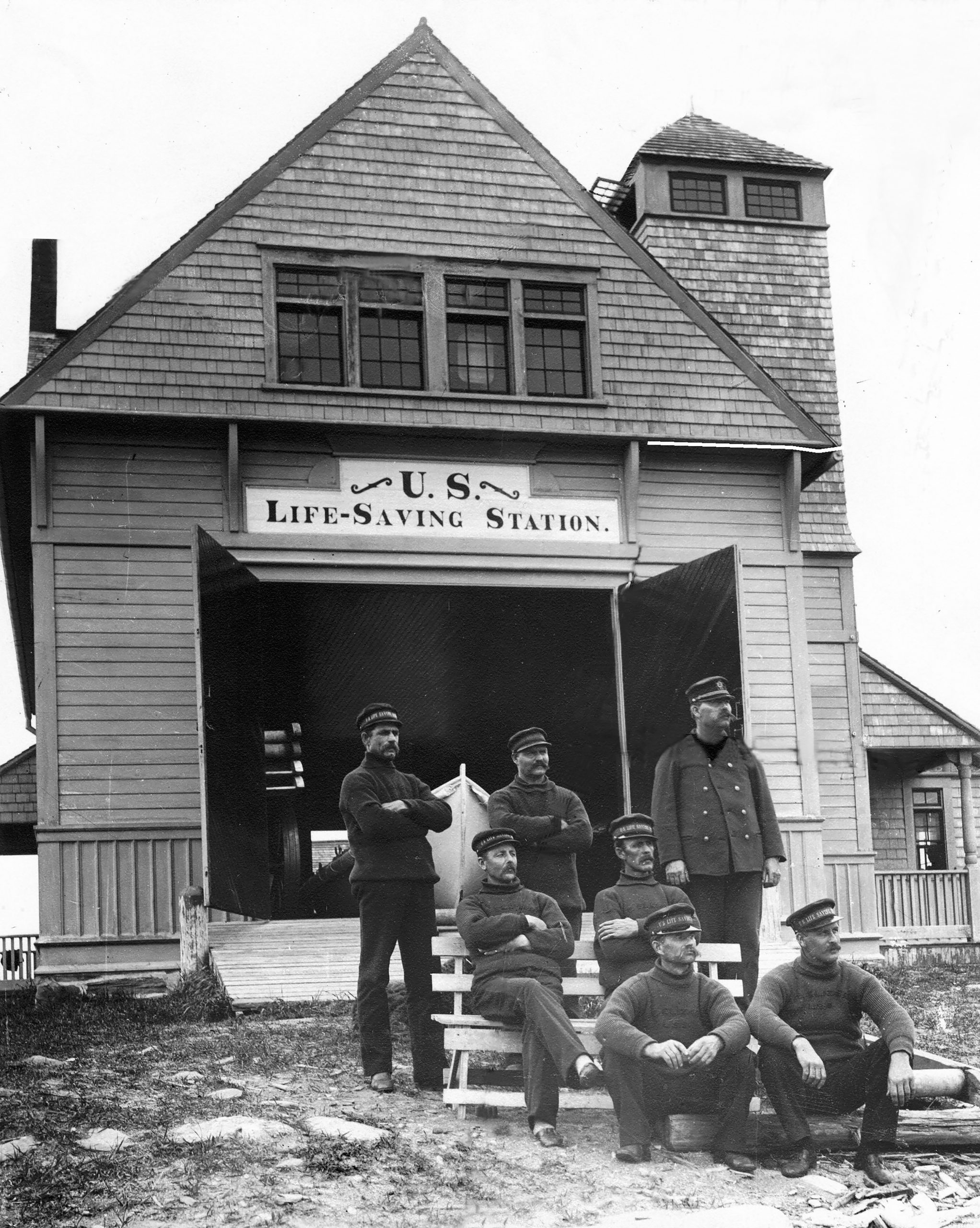 Cape Eliabeth's Life Saving Station, a building with a group of men in uniform on the steps.